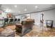 Finished basement area featuring a leather couch, bar seating, and an open layout perfect for entertaining at 719 Bethpage Dr, Mcdonough, GA 30253