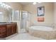 Spacious bathroom with tiled floor and features including a large tub and glass-enclosed shower at 719 Bethpage Dr, Mcdonough, GA 30253