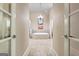A view into the main bathroom, featuring a tub and tiled floor at 719 Bethpage Dr, Mcdonough, GA 30253