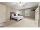 Bedroom featuring a ceiling fan, a bed and a large window with blinds at 719 Bethpage Dr, Mcdonough, GA 30253