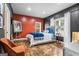 Stylishly decorated bedroom with a queen bed, accent wall and ample natural light from large windows at 719 Bethpage Dr, Mcdonough, GA 30253
