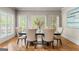 Elegant dining room featuring a dark wood table with seating for six and bright natural light at 719 Bethpage Dr, Mcdonough, GA 30253