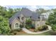 Aerial front view of a stunning brick home with lush landscaping and a well-maintained lawn at 719 Bethpage Dr, Mcdonough, GA 30253