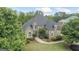 Aerial front view of a beautiful brick home with manicured lawn, mature trees, and well-maintained landscaping at 719 Bethpage Dr, Mcdonough, GA 30253