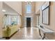 Grand foyer with soaring ceilings, statement chandelier, and view of the living spaces at 719 Bethpage Dr, Mcdonough, GA 30253