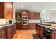 Spacious kitchen featuring dark wood cabinetry, granite countertops, and stainless-steel appliances at 719 Bethpage Dr, Mcdonough, GA 30253