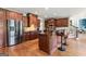 Kitchen with an island, stainless appliances, dark cabinets, and hardwood flooring at 719 Bethpage Dr, Mcdonough, GA 30253