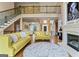 Open-concept living area with hardwood floors, soaring ceilings, and a view of the staircase and second-story landing at 719 Bethpage Dr, Mcdonough, GA 30253