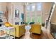 Elegant living room with soaring ceilings, a fireplace, and large windows at 719 Bethpage Dr, Mcdonough, GA 30253
