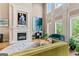 Bright living room with fireplace, tall windows, and comfortable, colorful seating, creating a welcoming space at 719 Bethpage Dr, Mcdonough, GA 30253
