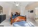 Large bedroom features vaulted ceilings with fan, bed and desk with adjacent en suite bathroom at 719 Bethpage Dr, Mcdonough, GA 30253