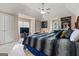 Spacious main bedroom with a ceiling fan, vaulted ceiling, carpet, and large bed with decorative pillows at 719 Bethpage Dr, Mcdonough, GA 30253