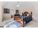Bedroom showcasing a bed, vaulted ceiling with fan, art and a desk with a large window at 719 Bethpage Dr, Mcdonough, GA 30253