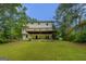 Exterior view of home with deck and lush green yard at 1201 Justin Ln, Lithonia, GA 30058
