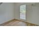 Cozy bedroom featuring wood floors and a window with natural light at 1201 Justin Ln, Lithonia, GA 30058