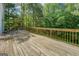 Large wooden deck offers ample outdoor living space with natural wooded backdrop at 1201 Justin Ln, Lithonia, GA 30058