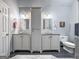 Bathroom features dual sinks, granite countertops, and a central cabinet for added storage space at 235 Surrey Park Dr, Fayetteville, GA 30215