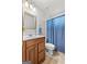 Classic bathroom featuring a wood vanity, and shower with blue curtain at 235 Surrey Park Dr, Fayetteville, GA 30215