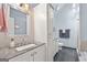 Stylish bathroom with white cabinets, granite countertop, and tiled shower area at 235 Surrey Park Dr, Fayetteville, GA 30215