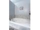 Bathroom features a modern soaking tub with tile surround, perfect for relaxation at 235 Surrey Park Dr, Fayetteville, GA 30215