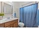 Cozy bathroom with wood vanity, sink, and blue shower curtain at 235 Surrey Park Dr, Fayetteville, GA 30215