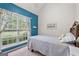 Bedroom featuring large window, blue accent wall, and plush carpet at 235 Surrey Park Dr, Fayetteville, GA 30215