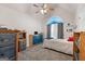 Bedroom with vaulted ceiling, fan, and an arched window with curtains at 235 Surrey Park Dr, Fayetteville, GA 30215