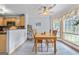 Cozy dining area with wood table set, bay window, and natural light adjoining kitchen at 235 Surrey Park Dr, Fayetteville, GA 30215