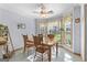 Bright dining area featuring a wood table set and large bay windows overlooking yard at 235 Surrey Park Dr, Fayetteville, GA 30215