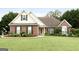 Charming brick home featuring a well-maintained lawn, tidy landscaping, and inviting curb appeal at 235 Surrey Park Dr, Fayetteville, GA 30215