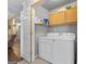 Practical laundry room with modern washer, dryer, storage cabinets, and tiled floors at 235 Surrey Park Dr, Fayetteville, GA 30215