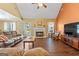 Inviting living room with a fireplace, ceiling fan, and comfortable seating arrangement for relaxation at 235 Surrey Park Dr, Fayetteville, GA 30215
