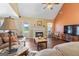 Cozy living room with a fireplace, ceiling fan, and comfortable furniture, perfect for relaxing at 235 Surrey Park Dr, Fayetteville, GA 30215