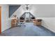 Cozy home office with blue carpet, and a large wooden desk situated under a ceiling fan at 235 Surrey Park Dr, Fayetteville, GA 30215