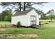 Exterior shot of the shed with a ramp in a grass field at 235 Surrey Park Dr, Fayetteville, GA 30215