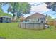 A full backyard, complete with a well-maintained above-ground pool, lush green lawn, a utility shed and wooded perimeter at 170 Habersham Dr, Fayetteville, GA 30214