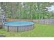 A fenced backyard featuring a well-maintained above-ground swimming pool and green grass at 170 Habersham Dr, Fayetteville, GA 30214