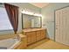 Primary bathroom with dual sink vanity, bathtub, and large mirror with vanity lighting at 170 Habersham Dr, Fayetteville, GA 30214