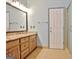 Bathroom with tile floors, dual vanities, and walk-in shower at 170 Habersham Dr, Fayetteville, GA 30214