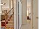 Inviting entryway showcasing the staircase, light wood floors, and a glimpse into the cozy main bedroom at 170 Habersham Dr, Fayetteville, GA 30214