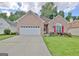 Charming brick home with a well-manicured lawn and vibrant flowerbeds enhancing curb appeal at 170 Habersham Dr, Fayetteville, GA 30214