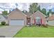 Charming brick home with a well-manicured lawn and vibrant flowerbeds enhancing curb appeal at 170 Habersham Dr, Fayetteville, GA 30214