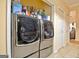 Convenient laundry area with modern stainless steel washer and dryer units, and extra storage space in this home at 170 Habersham Dr, Fayetteville, GA 30214