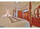 Detailed primary bedroom featuring wooden accents, a plush bed, and natural light from the window at 170 Habersham Dr, Fayetteville, GA 30214
