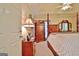 Luxurious primary bedroom with a four-poster bed, rich wood furniture, and soft lighting for a relaxing ambiance at 170 Habersham Dr, Fayetteville, GA 30214