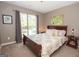 Bright bedroom with large window, hardwood floors, neutral color palette and minimalist décor at 11 Line Creek Cir, Sharpsburg, GA 30277