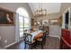 Spacious dining room with large windows, classic decor, hardwood floors, and modern lighting at 11 Line Creek Cir, Sharpsburg, GA 30277