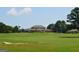 Expansive view of a golf course featuring a stylish clubhouse amid lush greenery at 11 Line Creek Cir, Sharpsburg, GA 30277
