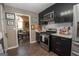 Bright kitchen featuring stainless steel appliances, dark cabinetry, light countertops, and eat-in breakfast area at 11 Line Creek Cir, Sharpsburg, GA 30277