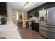 Modern kitchen features stainless steel appliances, dark cabinetry, stone backsplash and breakfast area at 11 Line Creek Cir, Sharpsburg, GA 30277